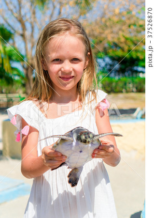 Adorable little girl with a small turtle in her Adorable little girl with a small turtle in her 37526870