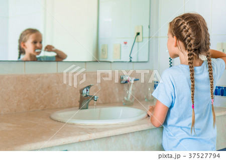 Little beautiful girl with white teeth brushes 37527794