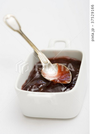 Plum jam in a small dish with a silver spoon Plum jam in a small dish with a silver spoon 37529166