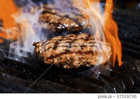 Flame grilled burgers on the grill 37529730