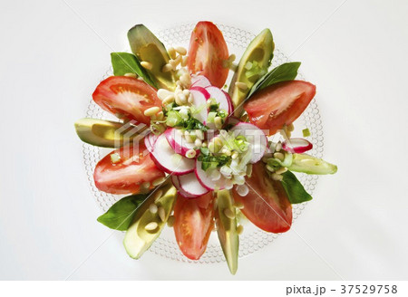 Tomato and avocado salad with radishes and pine nuts 37529758