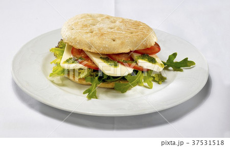 Ciabatta filled with tomato, mozzarella and rocket Ciabatta filled with tomato, mozzarella and rocket 37531518
