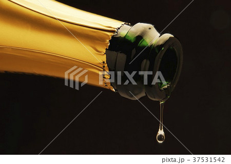 Sparkling wine dripping out of bottle 37531542