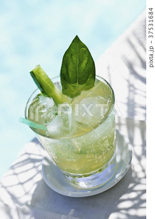 Glass of Ice Tea with Cucumber; Poolside 37531684
