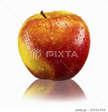Red and yellow apple with drops of water and reflection 37531744