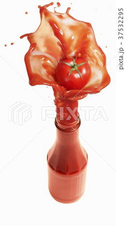 Tomato ketchup splashing out of bottle Tomato ketchup splashing out of bottle 37532295