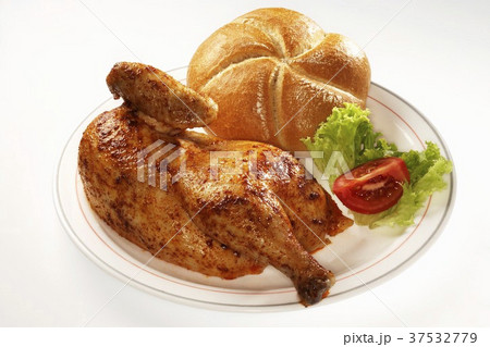 Half a roast chicken and a bread roll on a plate Half a roast chicken and a bread roll on a plate 37532779