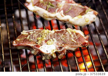 Marinated lamb chops on barbecue rack Marinated lamb chops on barbecue rack 37533639