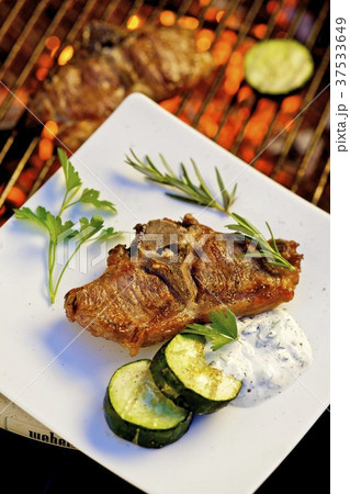 Barbecued lamb chop with cucumber and garlic & olive cream 37533649