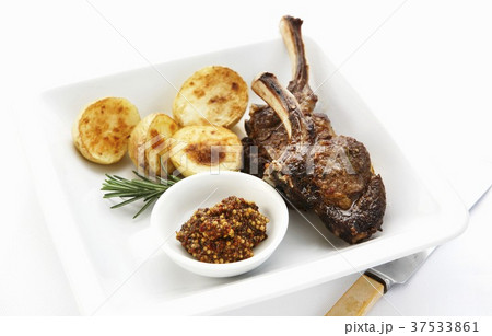 Lamb chops with roast potatoes, rosemary and mustard Lamb chops with roast potatoes, rosemary and mustard 37533861