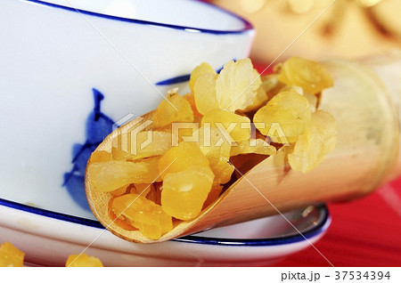 Chinese asparagus root in tea strainer, cup of tea 37534394