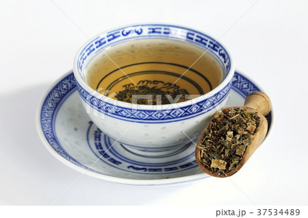 Rhubarb root in wooden scoop with tea Rhubarb root in wooden scoop with tea 37534489