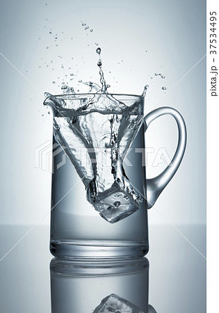 Ice cube falling into jug of water Ice cube falling into jug of water 37534495