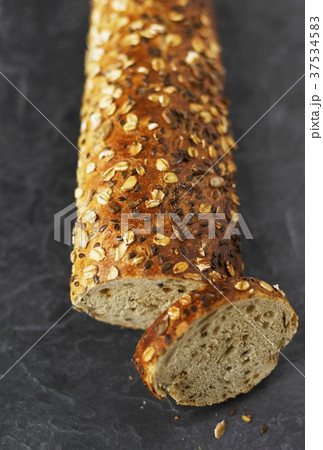 Multigrain baguette with a slice cut 37534583