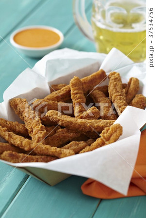 Basket of Chicken Fries with a Mug of Beer Basket of Chicken Fries with a Mug of Beer 37534756