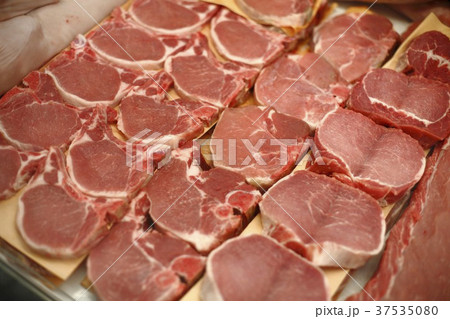 Pork Chops and Butterflied Pork Chops in a Display Case at a Market 37535080