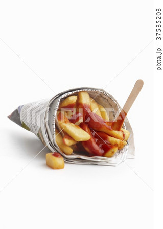 Chips with ketchup wrapped in newspaper 37535203