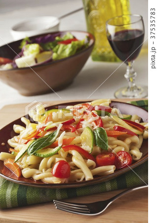 Pasta Primavera with Zucchini, Carrots, Red Pepper, Tomatoes, Basil and Grated Romano Cheese 37535783