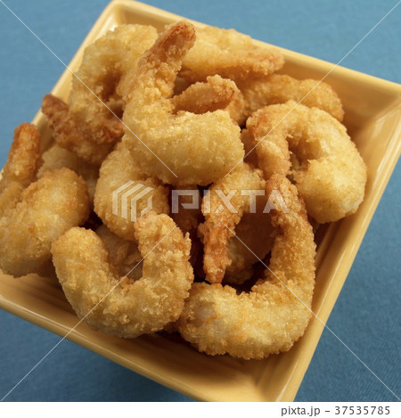 Battered Fried Shrimp in a Yellow Bowl on a Blue Background 37535785