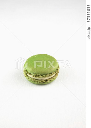 A Single Pistachio Macaroon on a White Background 37535853