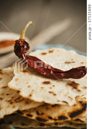 Dried Chili Pepper on a Stack of Crispy Tortillas Dried Chili Pepper on a Stack of Crispy Tortillas 37535899