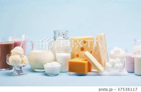 Various milk products (cheese, ice cream, milkshakes and milk) on a blue background 37536117