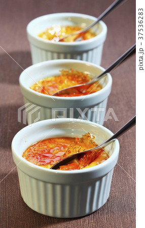 Three ramekins of creme brulee 37536283