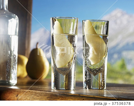 Two glasses of William's pear schnapps against an alpine backdrop 37536378