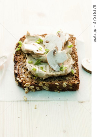 A slice of wholemeal bread topped with a mushroom spread 37536379