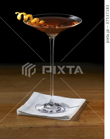 Sorriso Cocktail in a Stem Glass with Orange Peel Twist Garnish Sorriso Cocktail in a Stem Glass with Orange Peel Twist Garnish 37537183