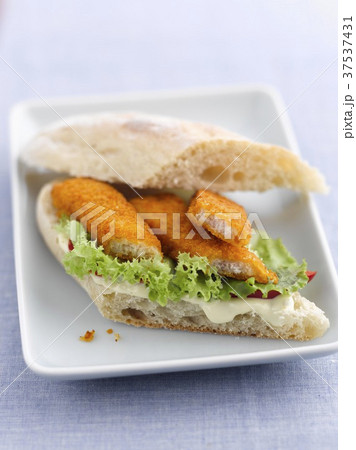A fish finger sandwich with lettuce and mayonnaise 37537431