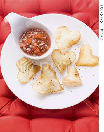 Heart-shaped crisps with a salsa dip Heart-shaped crisps with a salsa dip 37537653