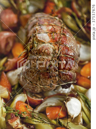 Beef shoulder fillet with herbs on a bed of vegetables 37537676