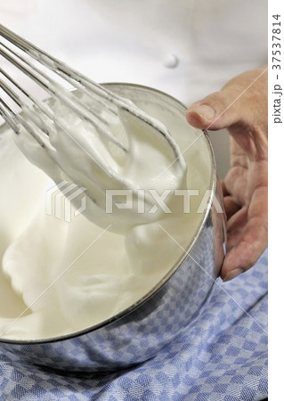 Whisking egg white and sugar together Whisking egg white and sugar together 37537814