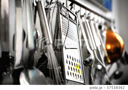 Various kitchen utensils hanging on a wall Various kitchen utensils hanging on a wall 37538362