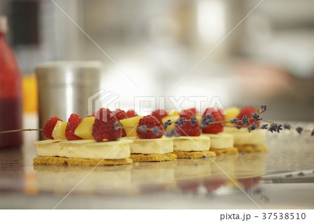 Cream slices topped with fruit kebabs 37538510