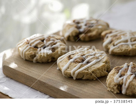 Cinnamon Scones with Icing on Cutting Board Cinnamon Scones with Icing on Cutting Board 37538545