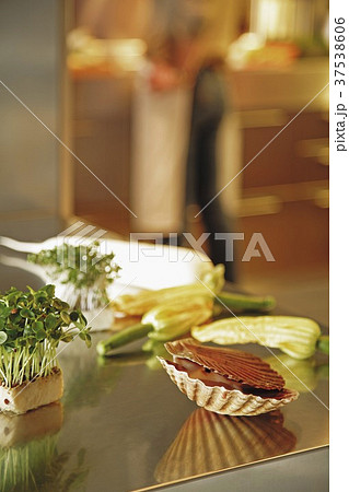 Scallops, courgette flowers, radish and cress on a work surface 37538606