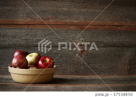 A Bowl of Assorted Apples in a Rustic Setting 37538650