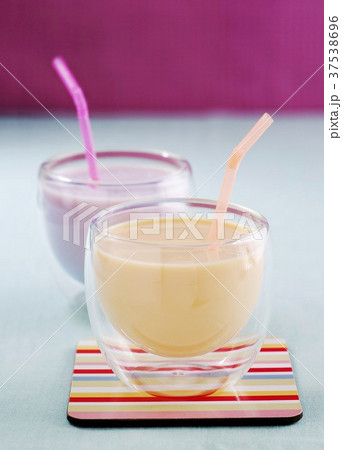 Mango lassi and a blueberry yogurt drink 37538696