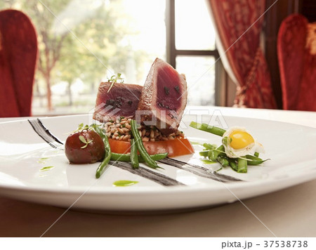 Pan Seared Yellowfin Hawaiian Tuna, Haricot Vert, Farro, Heirloom Tomatoes, Squid Ink, Fried Quail Egg, and Black Lava Sea Salt 37538738