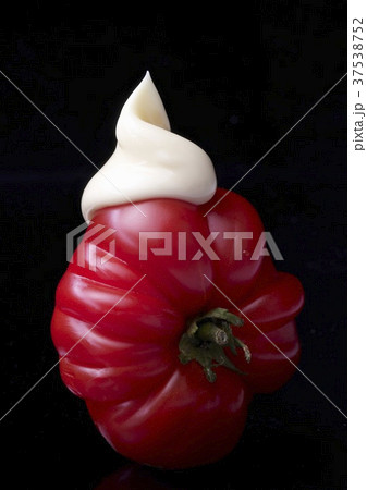 A slice of tomato with a dollop of mayonnaise A slice of tomato with a dollop of mayonnaise 37538752
