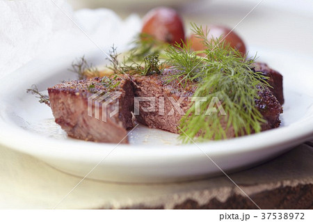 Steak with Fresh Dill and Potato on a White Plate 37538972