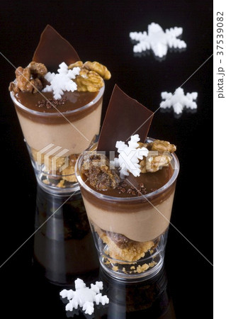 Two glasses of chocolate coffee mousse with nuts and sugar stars 37539082