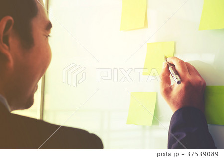 Businessman putting his ideas in Post-it planning 37539089