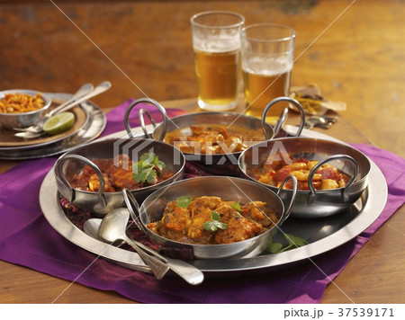 Four different types of curries on a tray 37539171