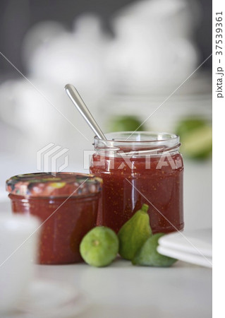 Two jars of strawberry jam and fresh figs 37539361