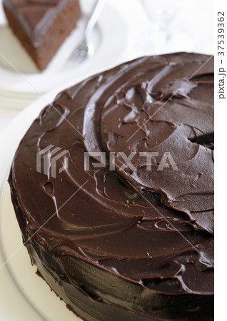 A chocolate cake topped with ganache A chocolate cake topped with ganache 37539362