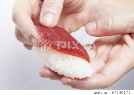 Hand Making Sashimi Sushi; Putting Tuna on Rice 37540175