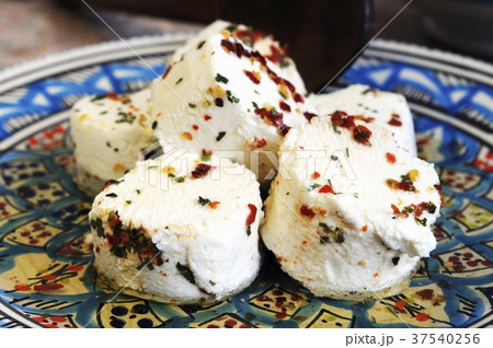 Marinated toma cheese with chilli and olive oil (Italy) 37540256